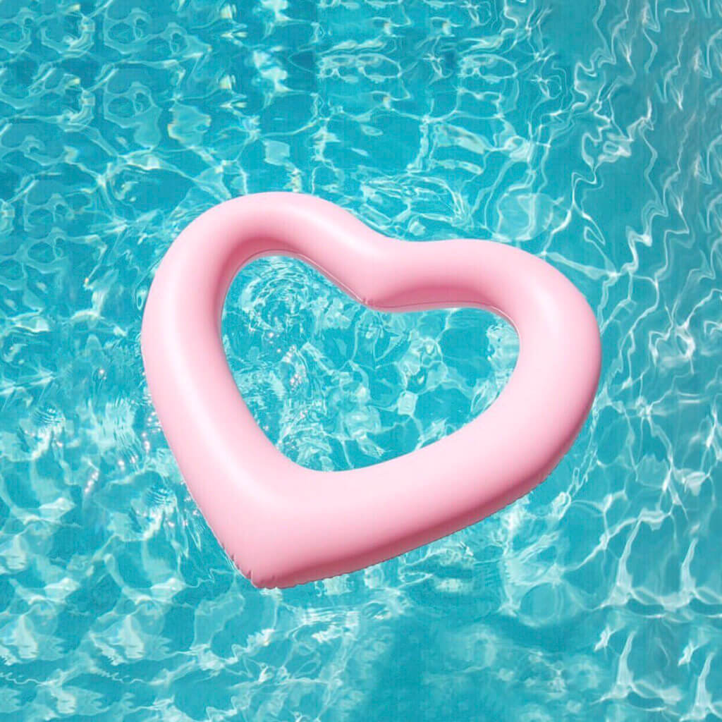 Romantic poolside detail with heart-shaped inflatable