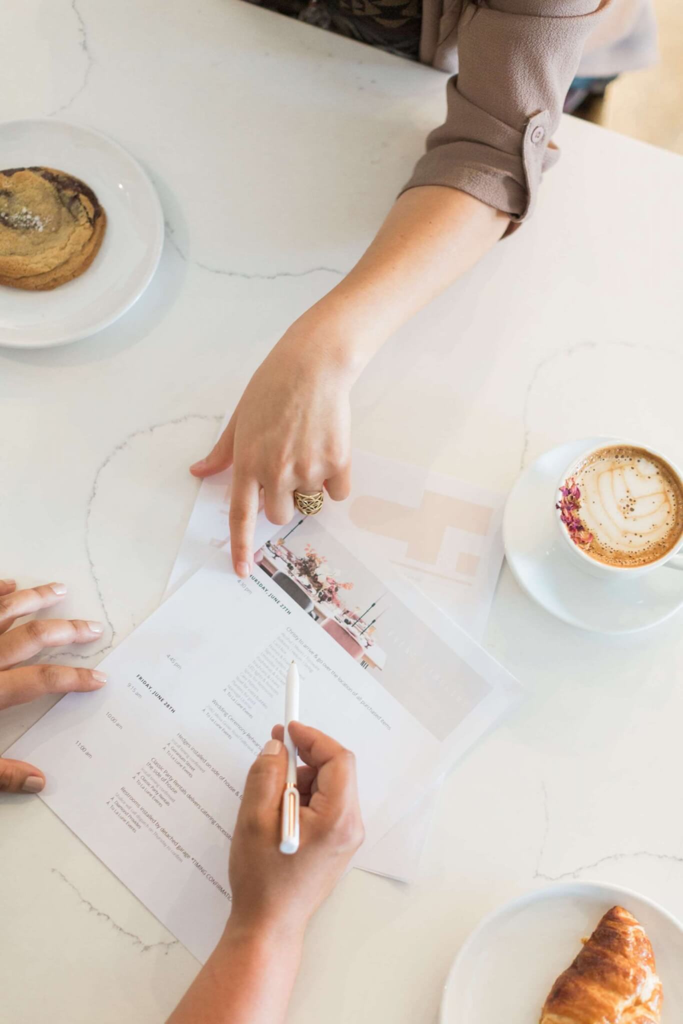 2 wedding planners double checking timelines