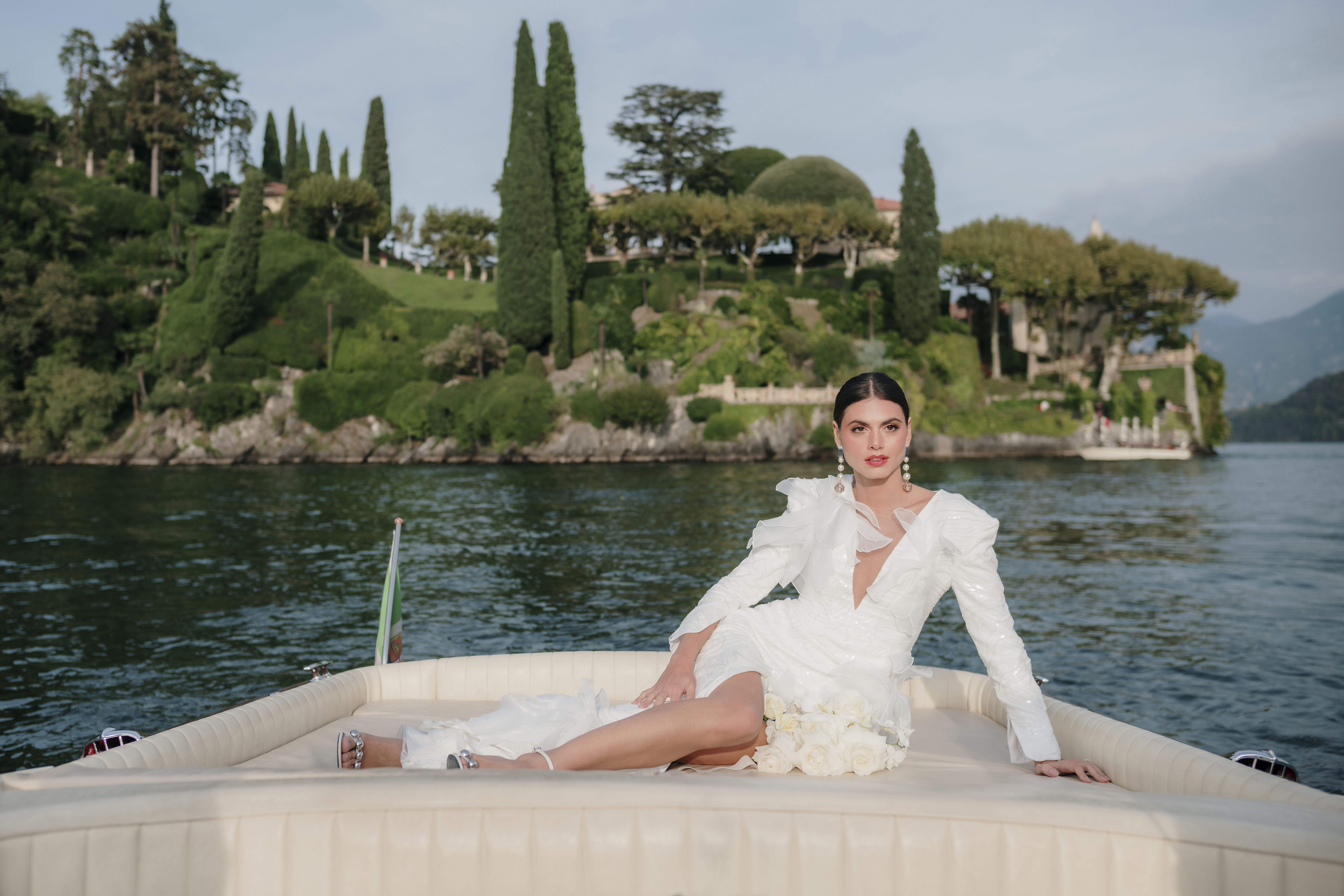 bride portrait on a Riva boat in lake como in front of villa balbianello