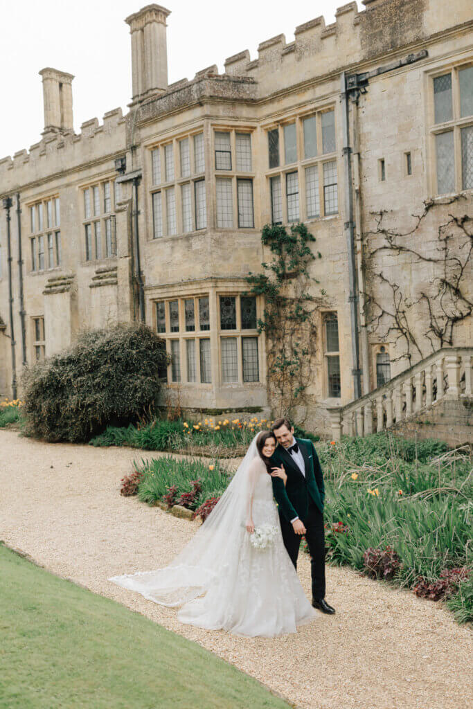 bride and groom in front of Sudeley Castle, perfect wedding venue if you're looking for a castle wedding venue