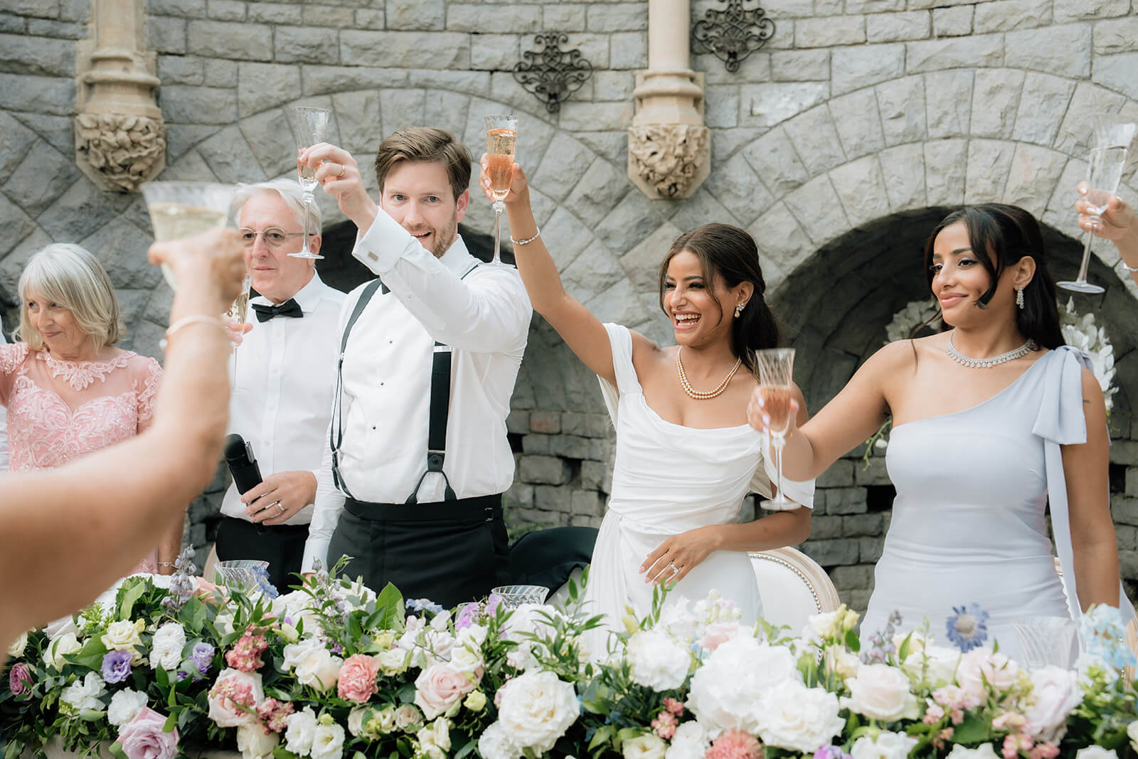 bride and groom raising a glass for toast during speech