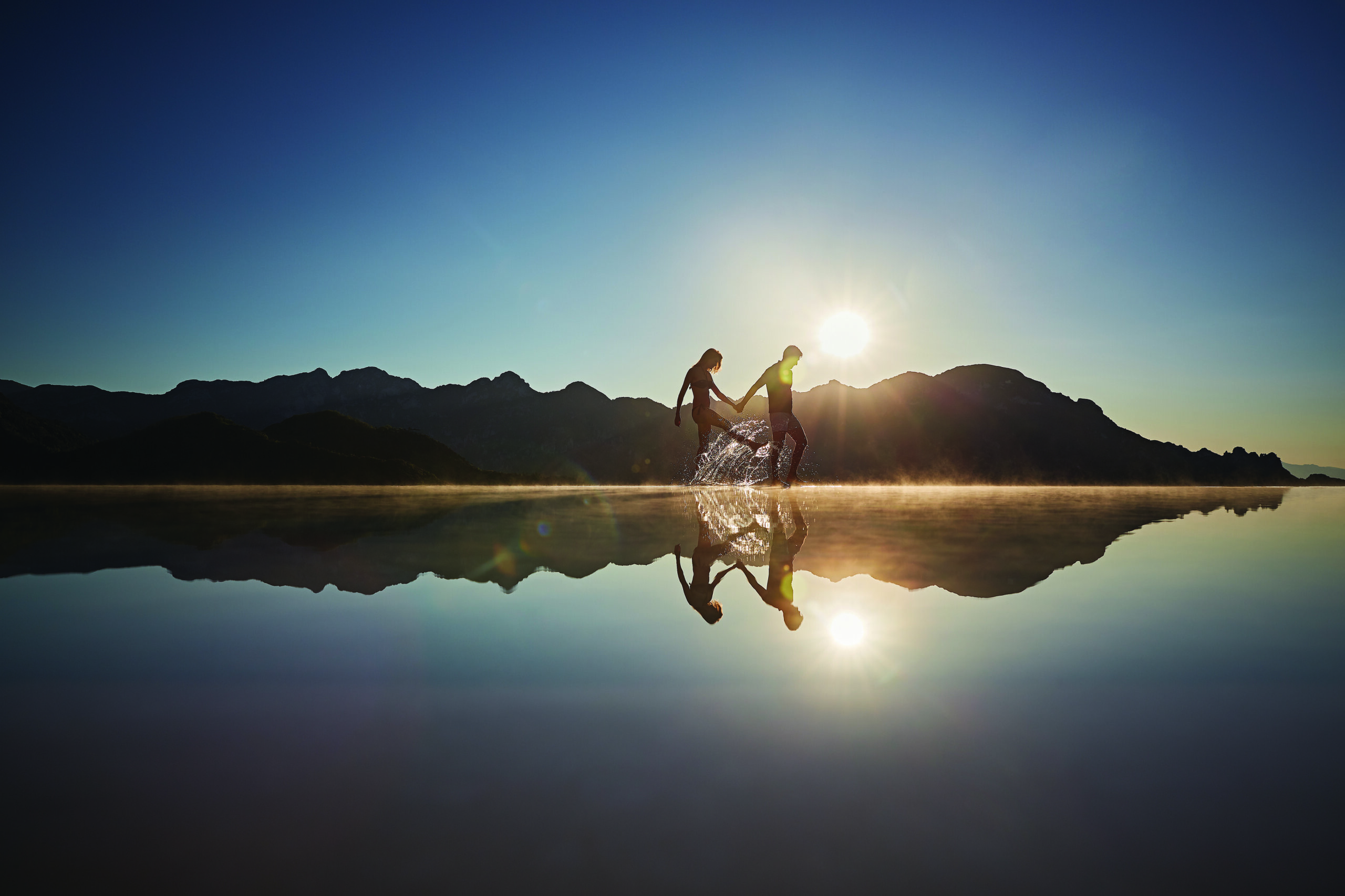 bride and groom walking on the edge of the infinity pool Belmond Hotel Caruso luxury wedding venue