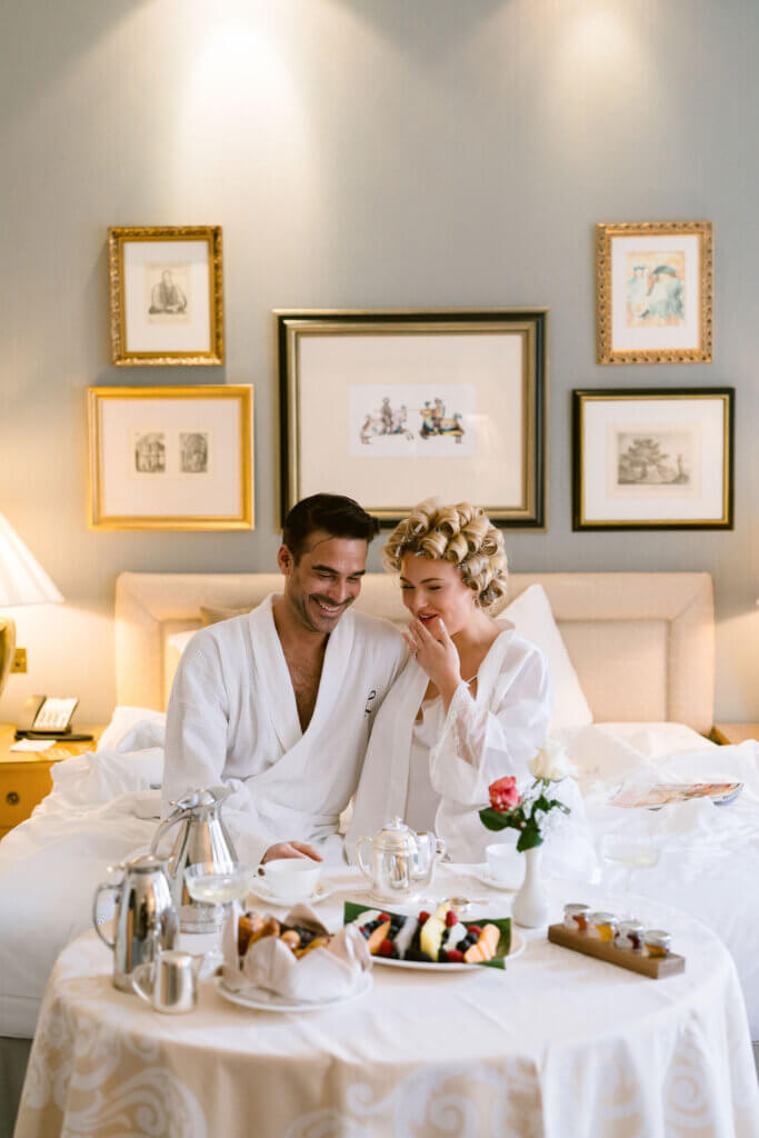 old hollywood wedding in Landmark suite. bride and groom having breakfast in bed - room service