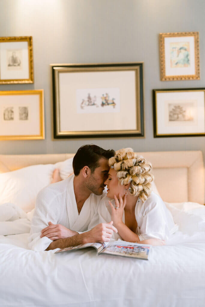 bride and groom on Landmark London suite bed touching their foreheads