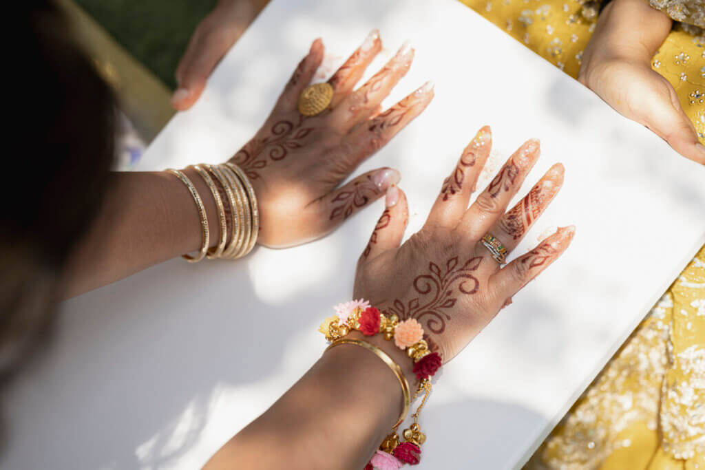 henna decorated hands during vibrant haldi ceremony in Tuscany villa  planned by Roberta Burcheri events