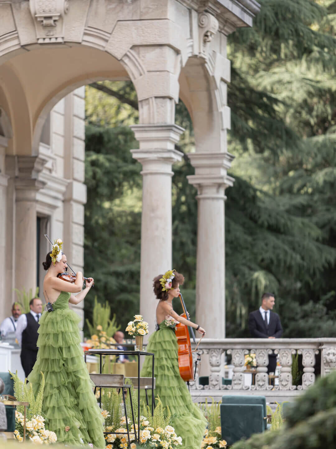 string quartet mid-performance, styled in a refined outdoor setting